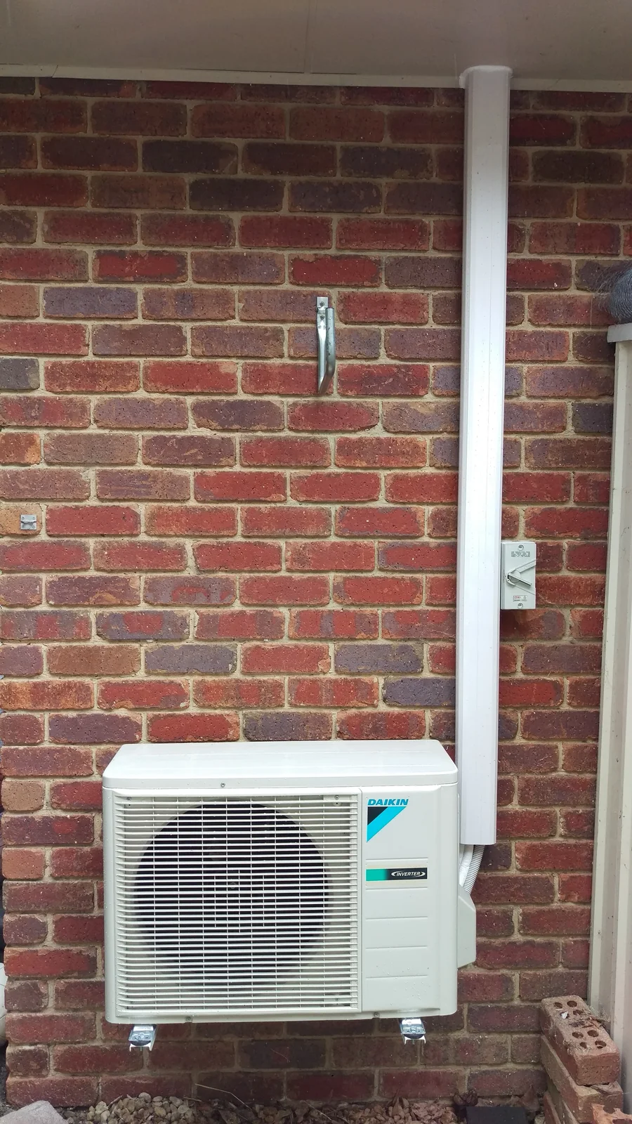 Daikin inverter split system outdoor unit installed on a brick wall in Melbourne
