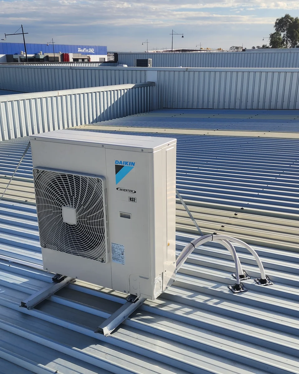 Daikin inverter outdoor unit installed on a commercial roof in Melbourne by Trigger Group