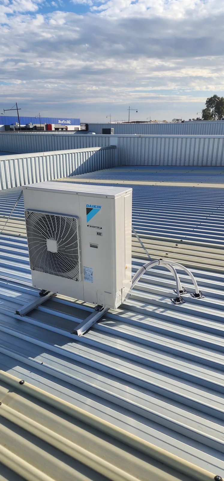 Daikin outdoor unit installed on a commercial metal roof