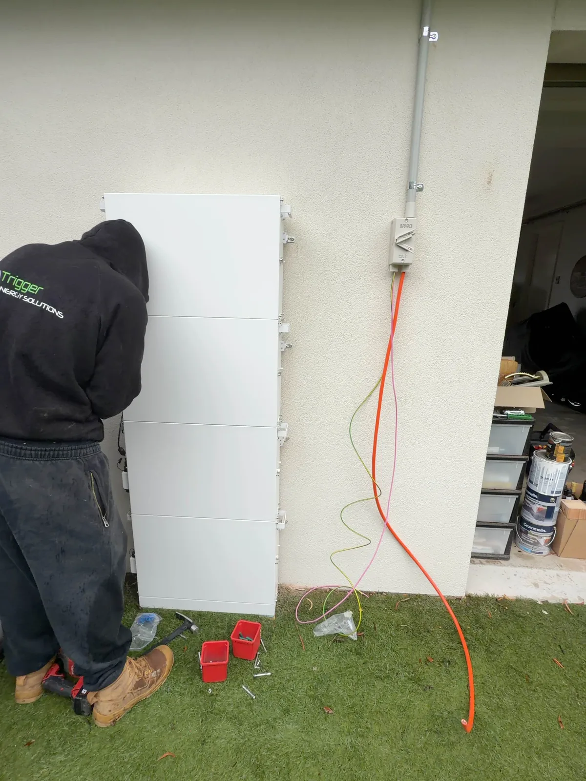 Trigger Energy Solutions electrician installing a home battery