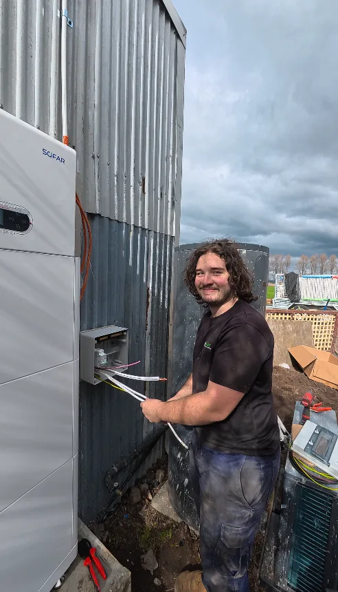 Trigger Energy Solutions electrician running cabling to a Sofar battery at a rural property