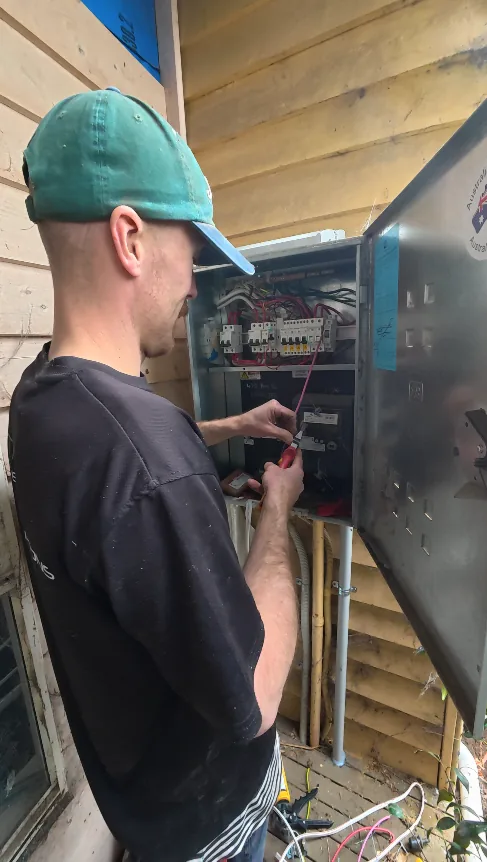 Trigger Energy Solutions electrician working at a meter box