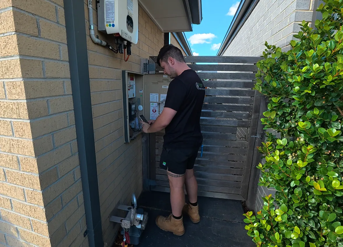 Trigger Energy Solutions electrician working inside a domestic switchboard