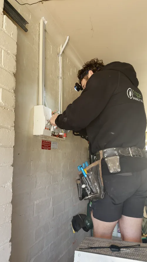 Electrician terminating wiring in a switchboard