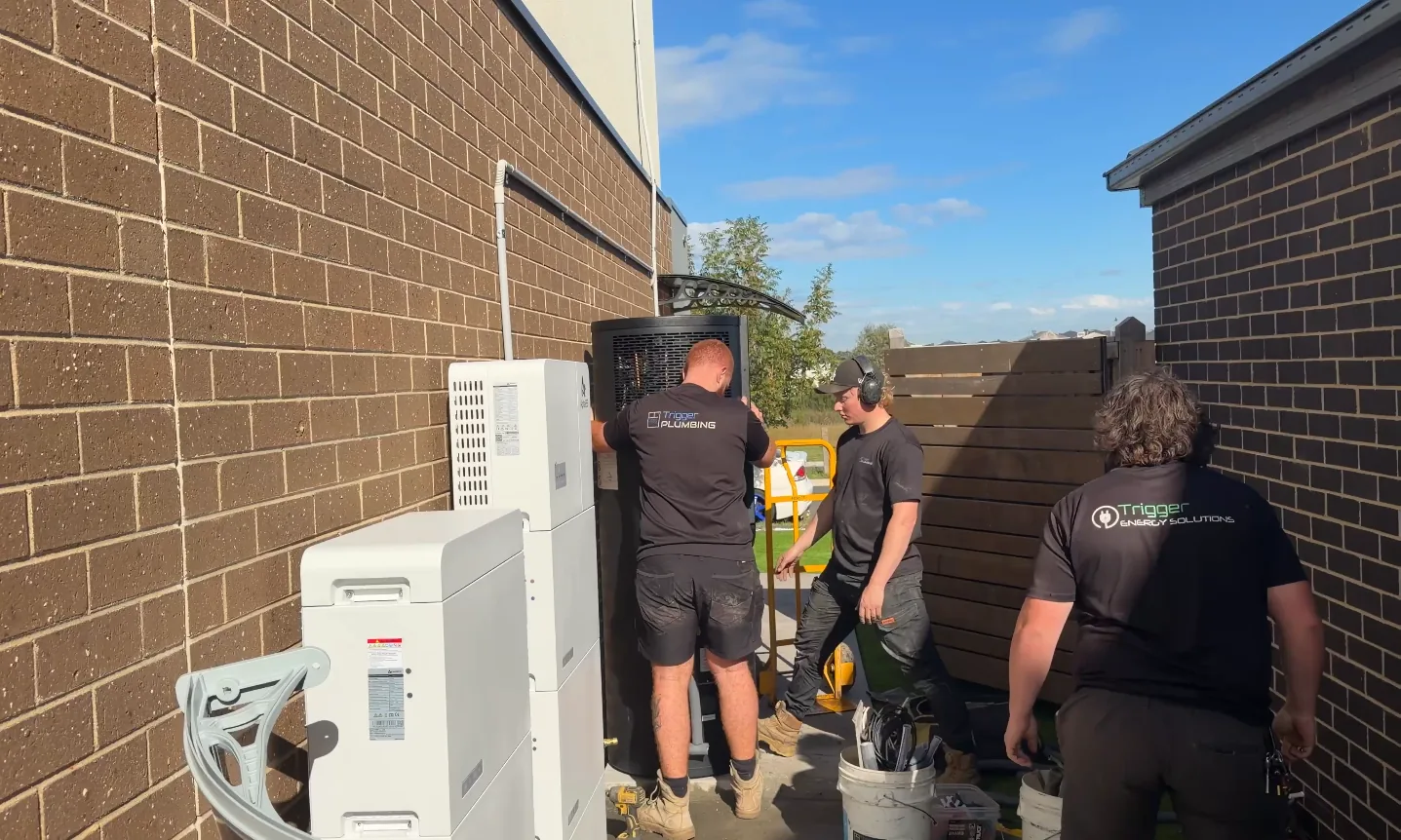 Trigger Plumbing and Trigger Energy Solutions crew on a heat pump and battery install