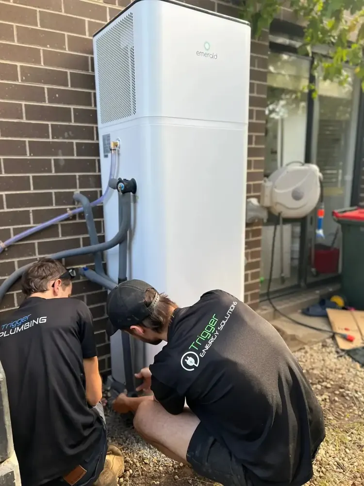 Trigger Group crew installing a NeoPower heat pump alongside a home battery in Melbourne