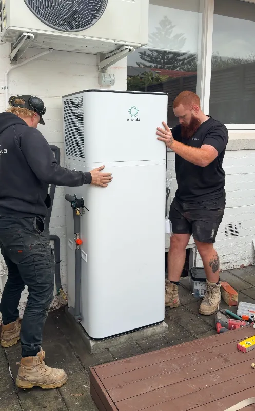 Trigger Group crew positioning a heat pump into place