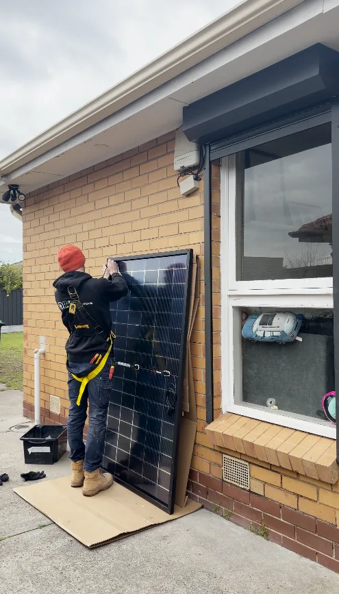 Trigger Energy Solutions electrician preparing a solar panel for installation