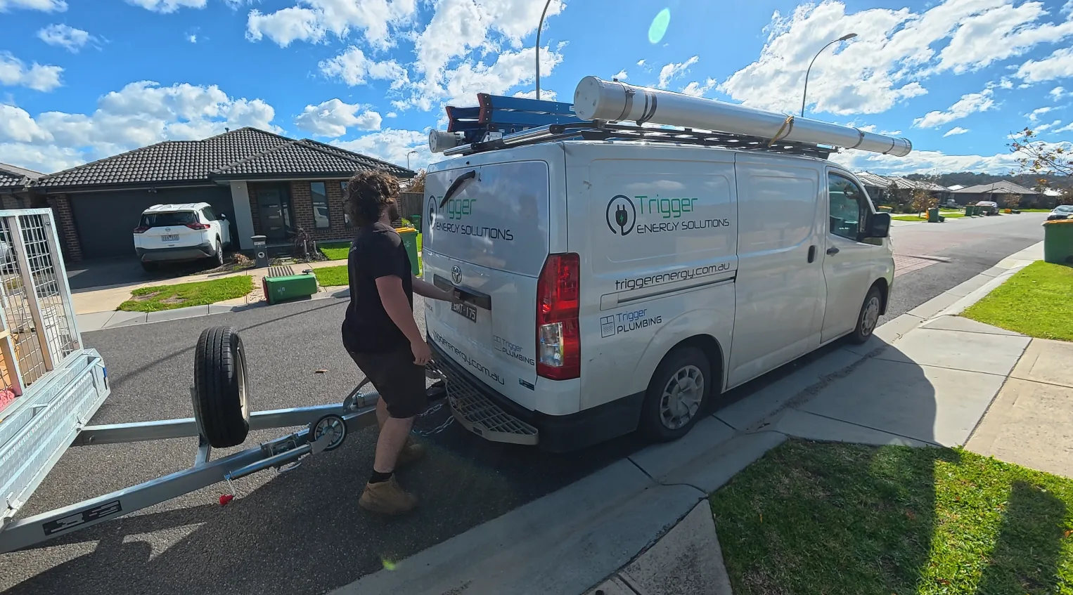 Trigger Energy Solutions van hitching a trailer outside a residential job